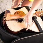 Travel guitar that folds in half