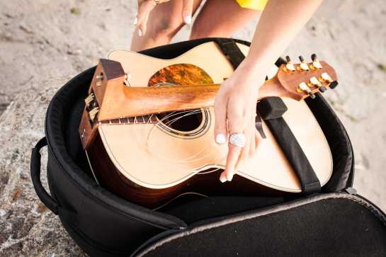 Travel guitar that folds in half